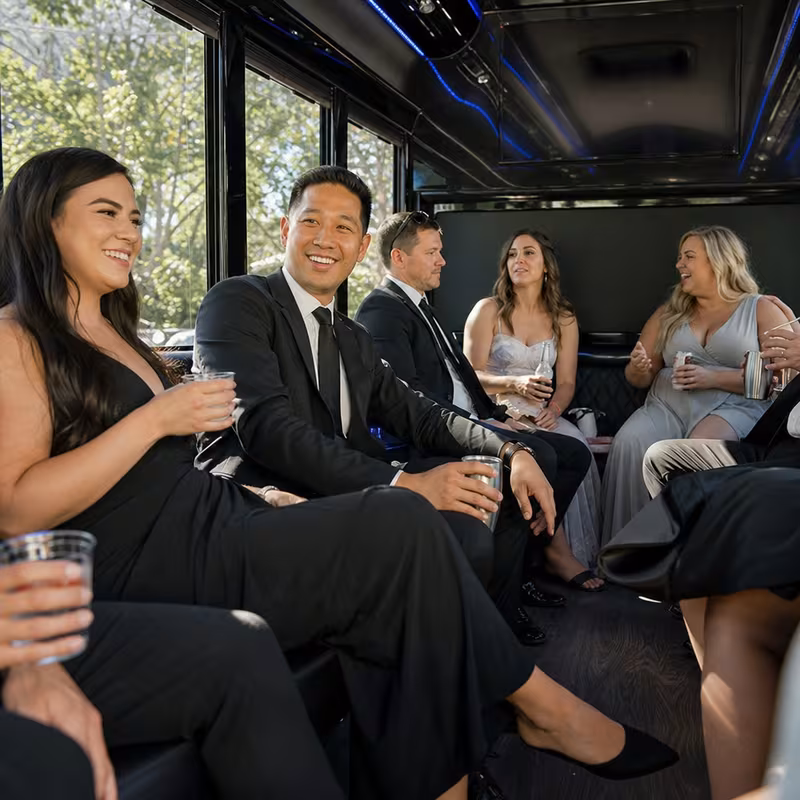 Wedding guests seated inside a Salem party bus