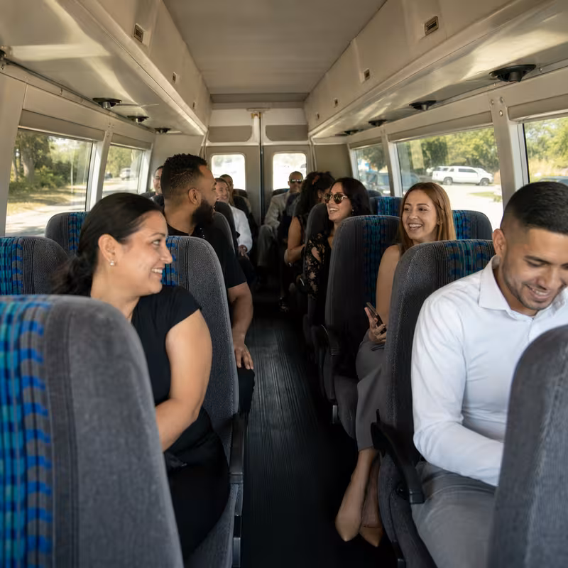 Group boarding a white charter bus for Private Event Transportation transportation in Salem