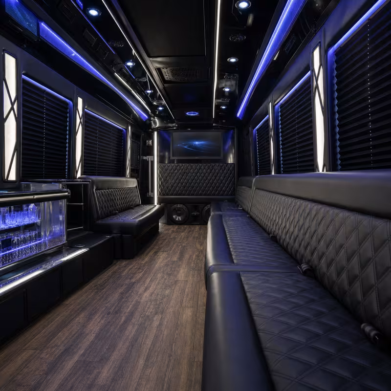 Party bus interior with wraparound leather seating and LED lighting in Salem