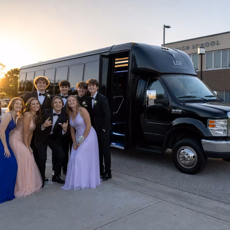 Group boarding a white charter bus for Prom & Homecoming Transportation transportation in Salem