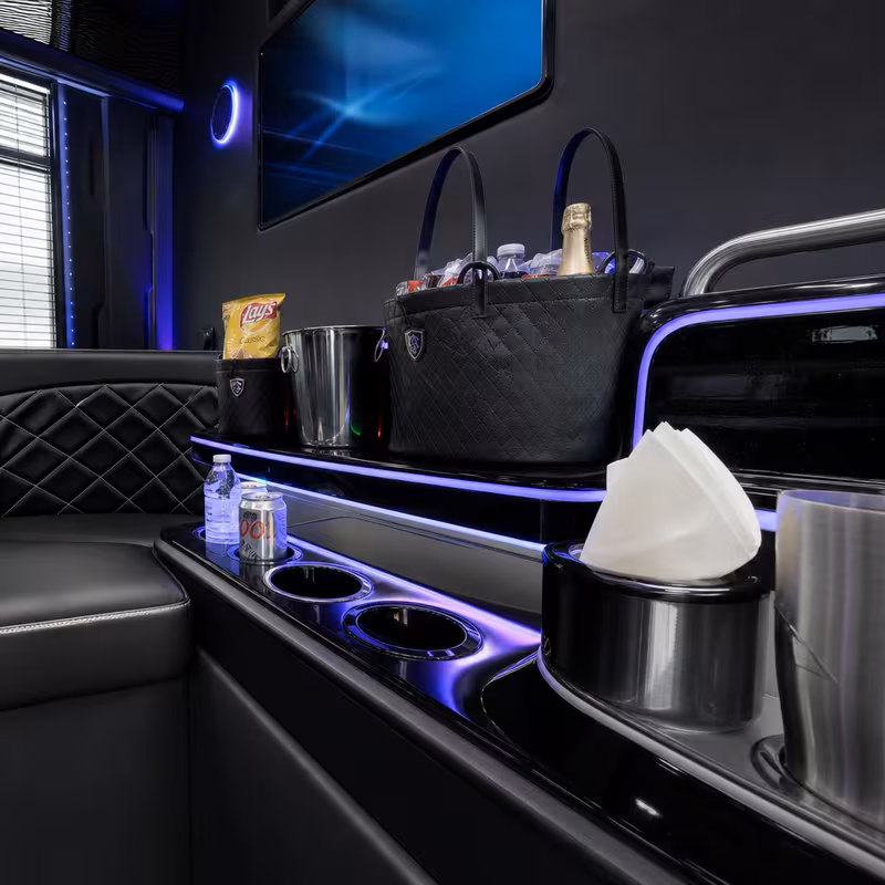 Party bus interior with wraparound leather seating and LED lighting in Salem